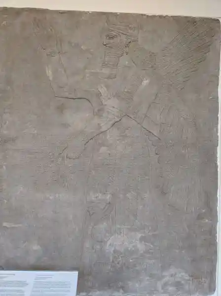 Relief, winged man holding solar discs, located at the Pergamon museum